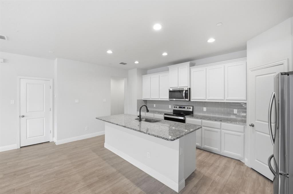 5960 Bursey Road Watauga, TX 76148 - Photo 14 of 38 a kitchen with a sink stove and refrigerator