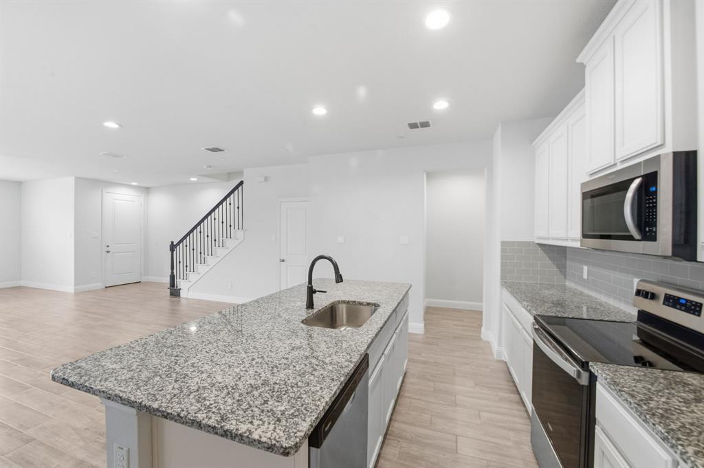 5960 Bursey Road Watauga, TX 76148 - Photo 15 of 38 a kitchen with sink stove and kitchen island