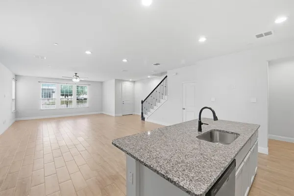 a kitchen with a faucet a sink and a window