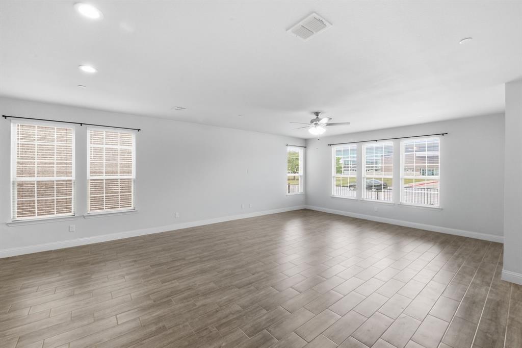 5960 Bursey Road Watauga, TX 76148 - Photo 18 of 38 an empty room with wooden floor and windows