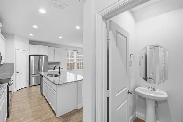 a kitchen with stainless steel appliances a sink stove and refrigerator