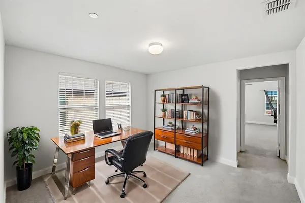 a view of a workspace with furniture and cabinet
