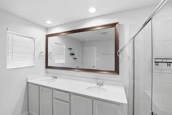 a bathroom with a double vanity sink mirror and