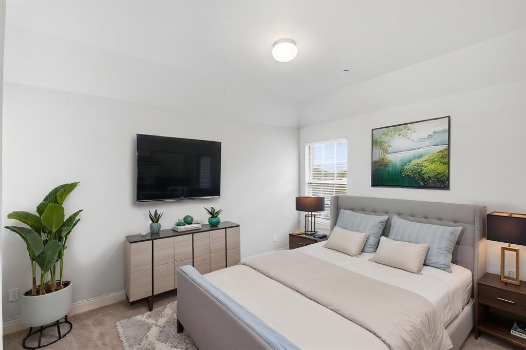 5960 Bursey Road Watauga, TX 76148 - Photo 30 of 38 a bedroom with a bed and a flat screen tv