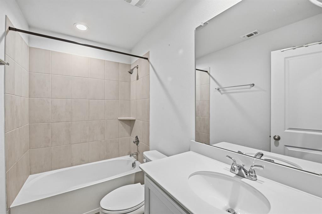 5960 Bursey Road Watauga, TX 76148 - Photo 35 of 38 a bathroom with a sink toilet and shower