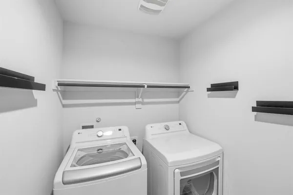a view of storage and utility room with washer and dryer