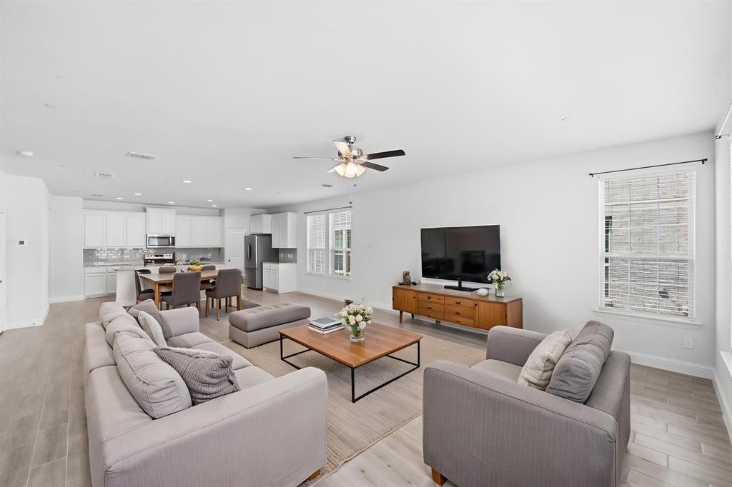 5960 Bursey Road Watauga, TX 76148 - Photo 9 of 38 a living room with furniture and a flat screen tv