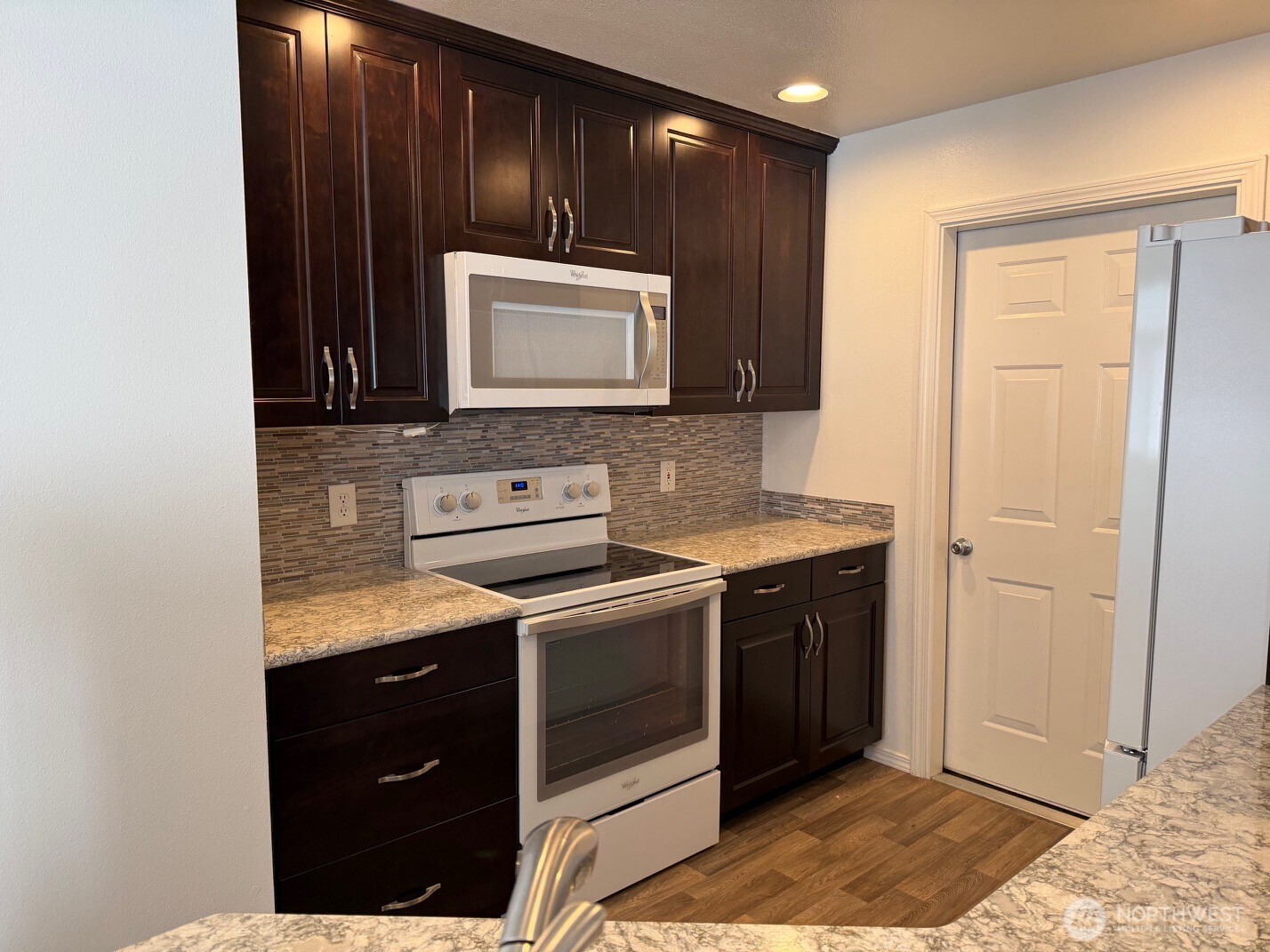 23512 55th Avenue South, Unit 16 Kent, WA 98032 - Photo 2 of 19 a kitchen with a stove microwave and sink