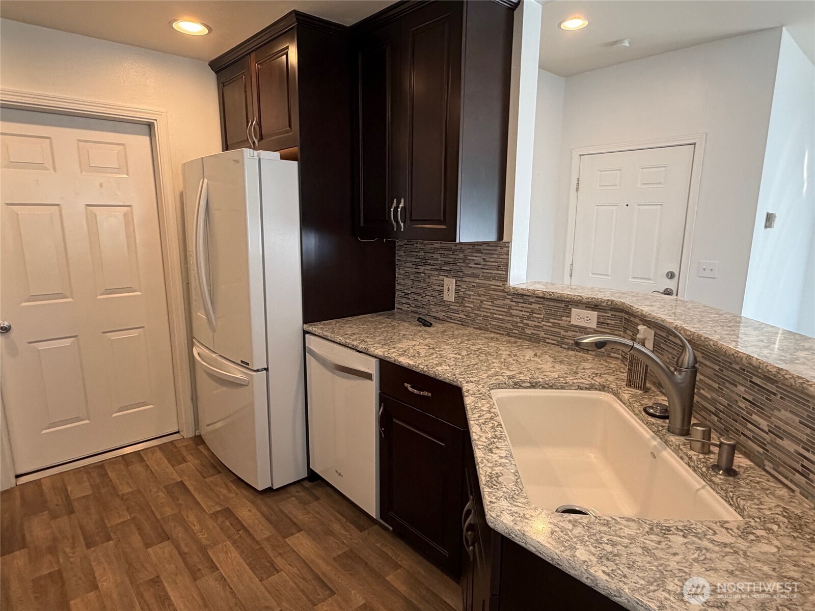 23512 55th Avenue South, Unit 16 Kent, WA 98032 - Photo 4 of 19 a kitchen with granite countertop a refrigerator and a sink