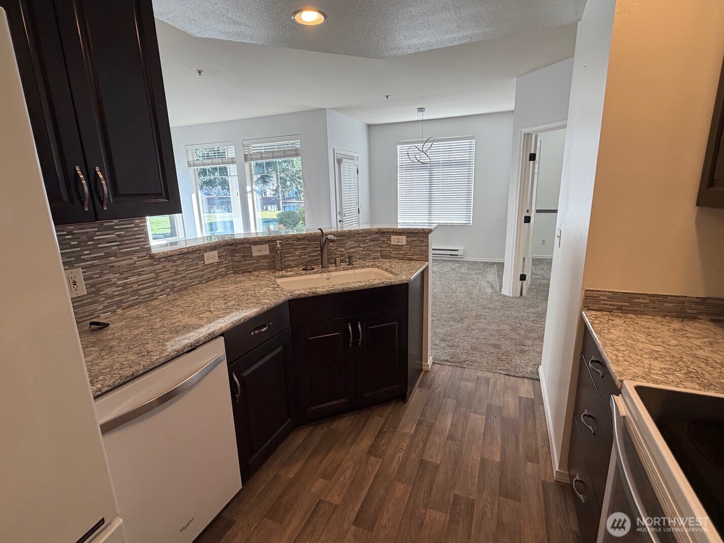23512 55th Avenue South, Unit 16 Kent, WA 98032 - Photo 6 of 19 a kitchen with a sink stove and refrigerator