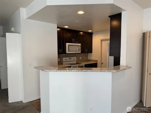 a kitchen with stainless steel appliances a refrigerator and a stove