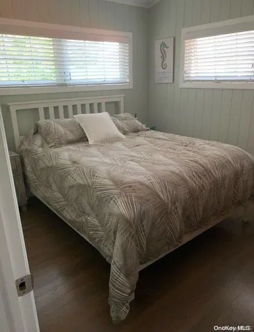 a bed sitting in a bedroom next to a window