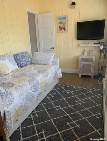 a bedroom with a bed and a flat screen tv