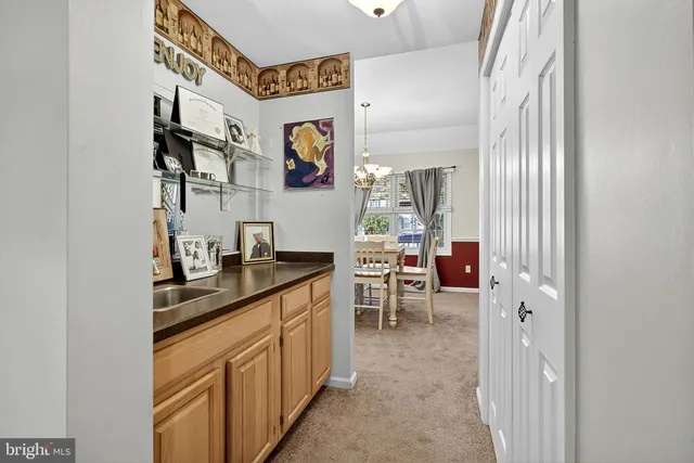 a living room with furniture a fireplace and a chandelier