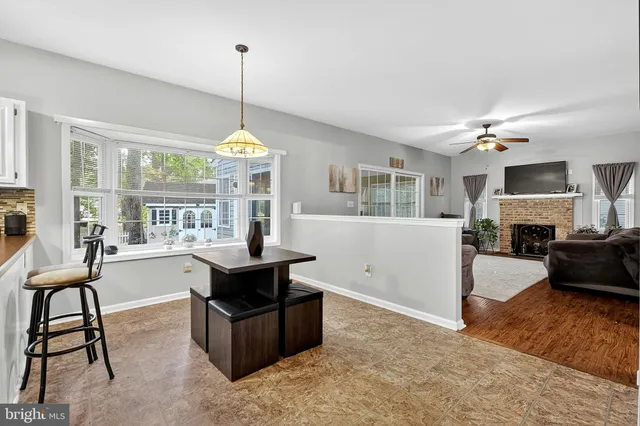 a view of a livingroom with a ceiling fan and window
