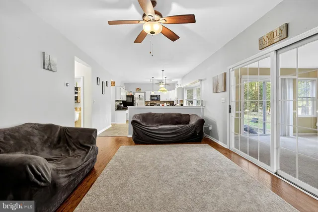 a bed sitting in a spacious bedroom next to a window