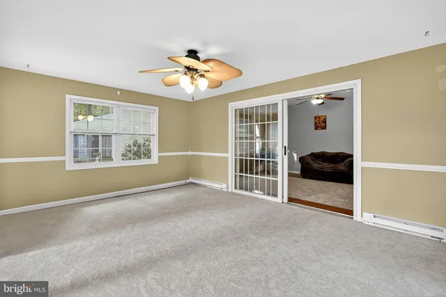 a bathroom with a tub a sink double vanity and a window