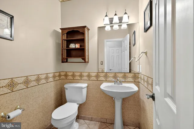 a bathroom with a tub a sink double vanity and a mirror