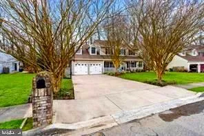 an aerial view of a house with garden space and a lake view