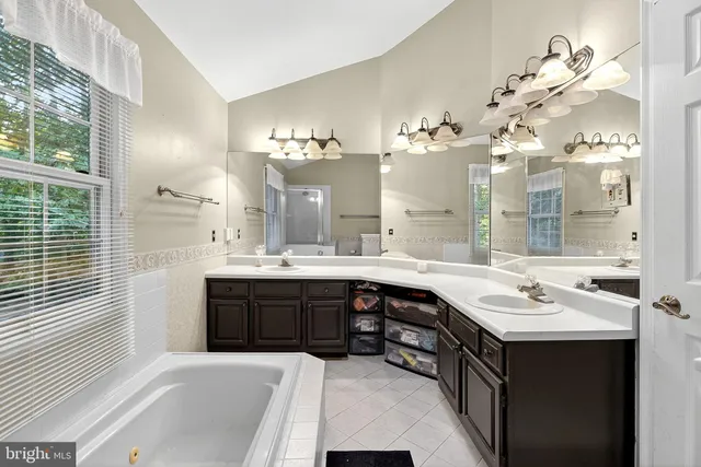 a view of a room with a chandelier fan and windows