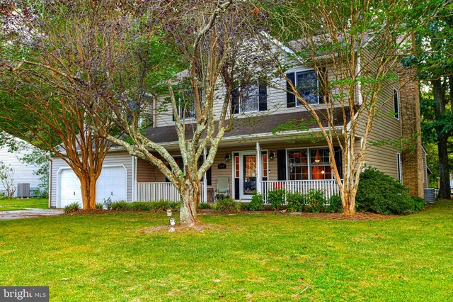 a view of a dining room with furniture and a chandelier