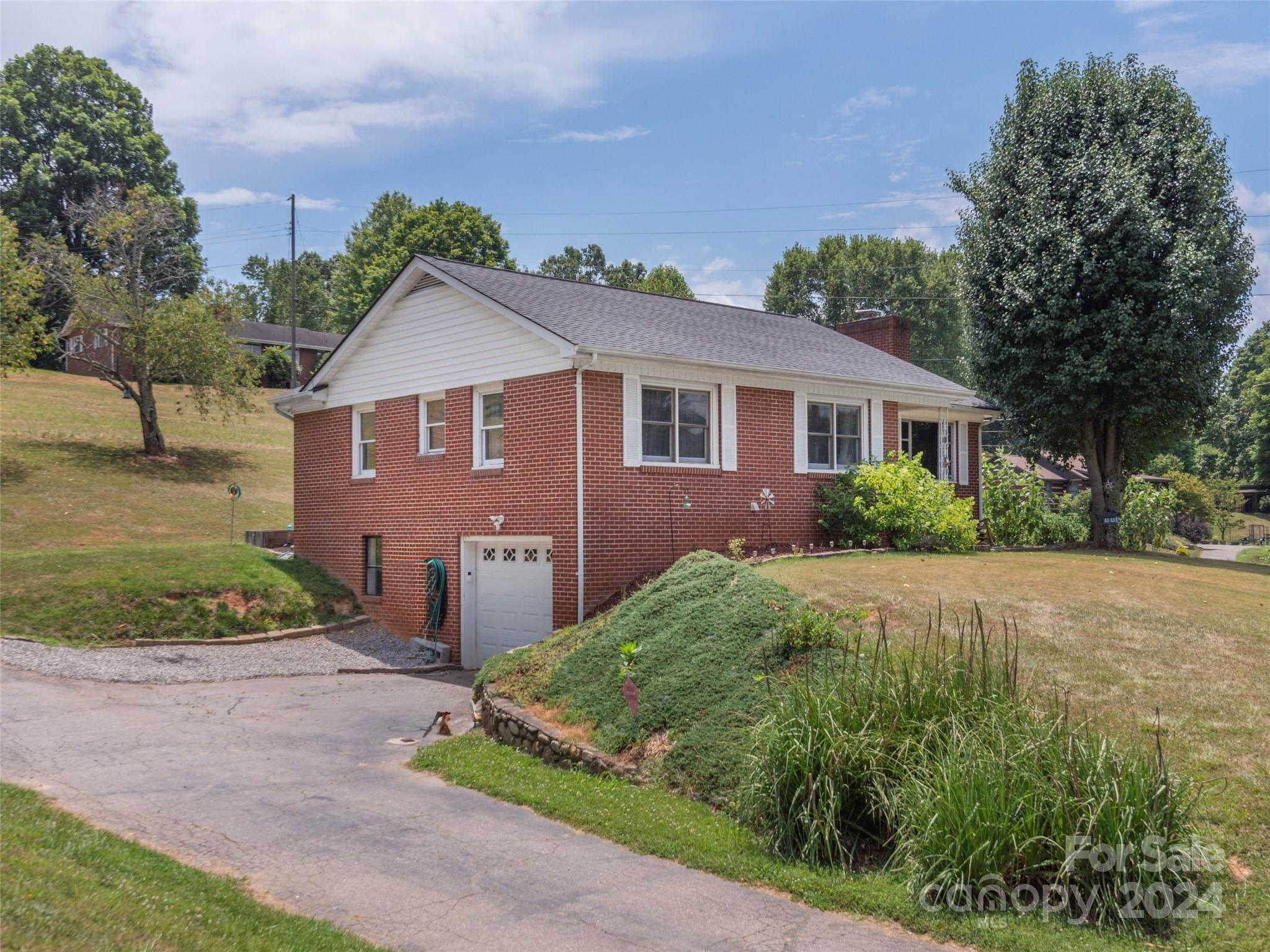 4784 Old Clyde Road Clyde, NC 28721 - Photo 1 of 23 a front view of a house with garden