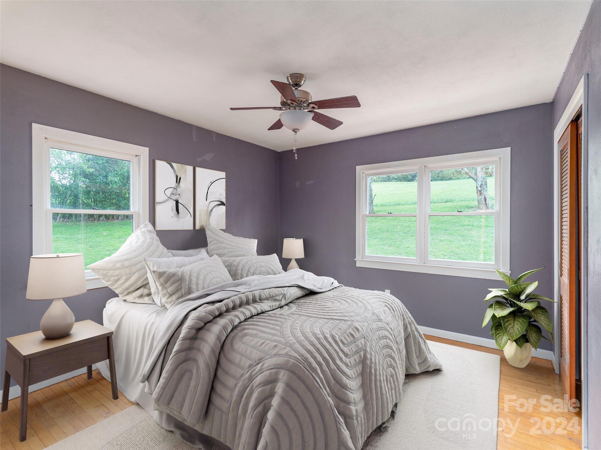 4784 Old Clyde Road Clyde, NC 28721 - Photo 12 of 23 a bedroom with a bed and a chandelier