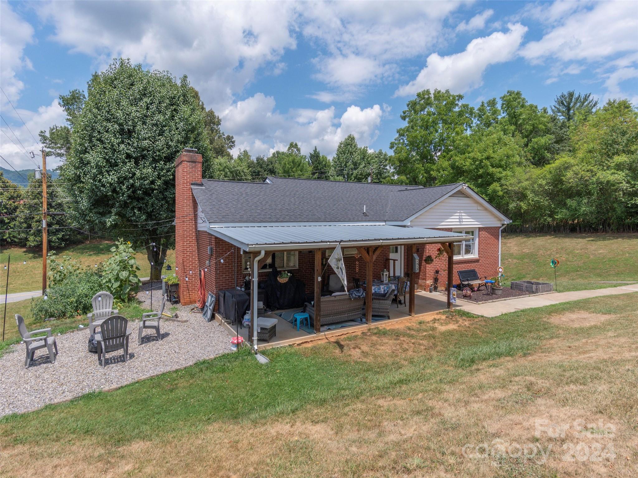 4784 Old Clyde Road Clyde, NC 28721 - Photo 2 of 23 a view of a house with a yard patio and a garden