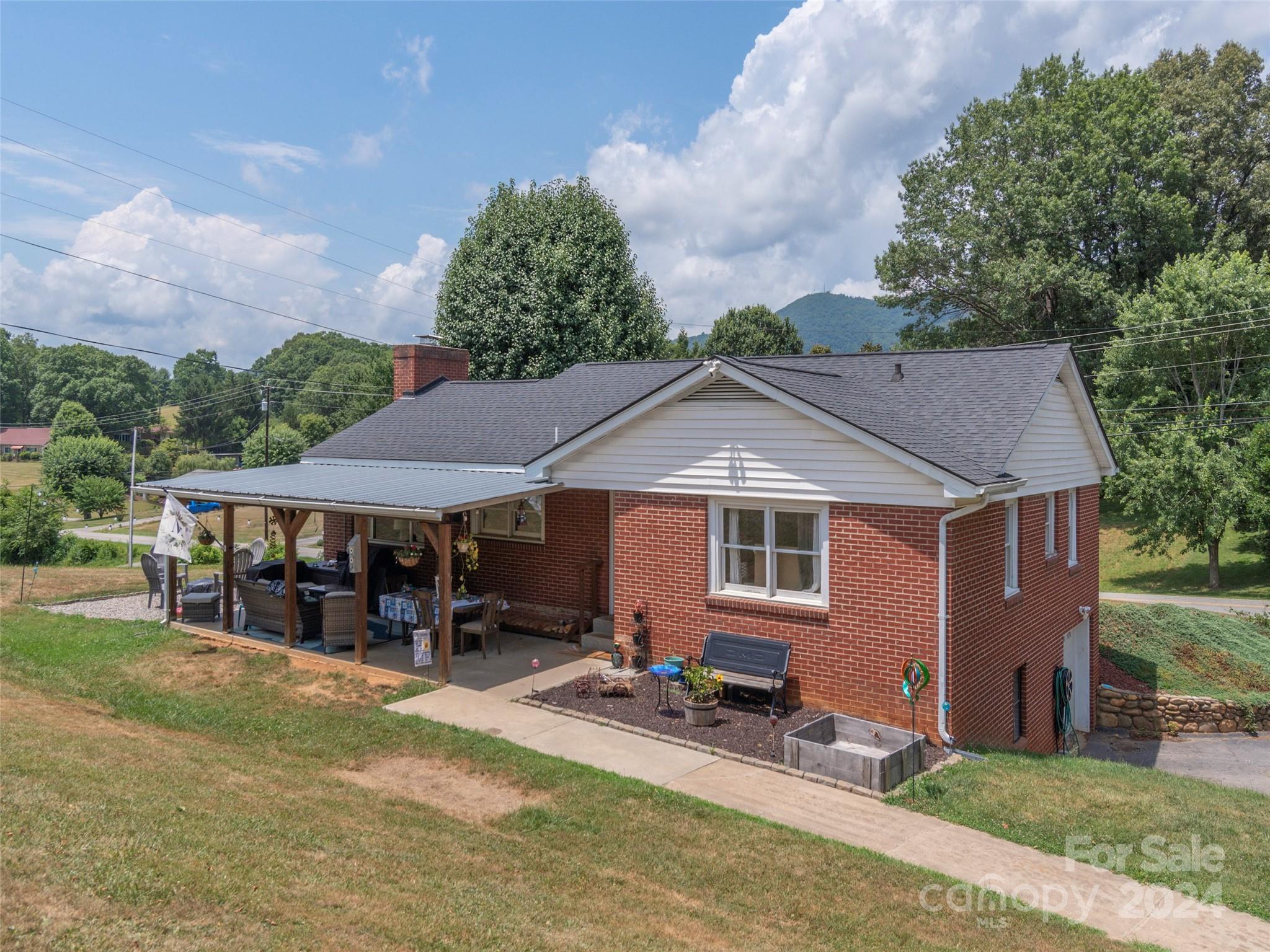 4784 Old Clyde Road Clyde, NC 28721 - Photo 21 of 23 a front view of a house with garden