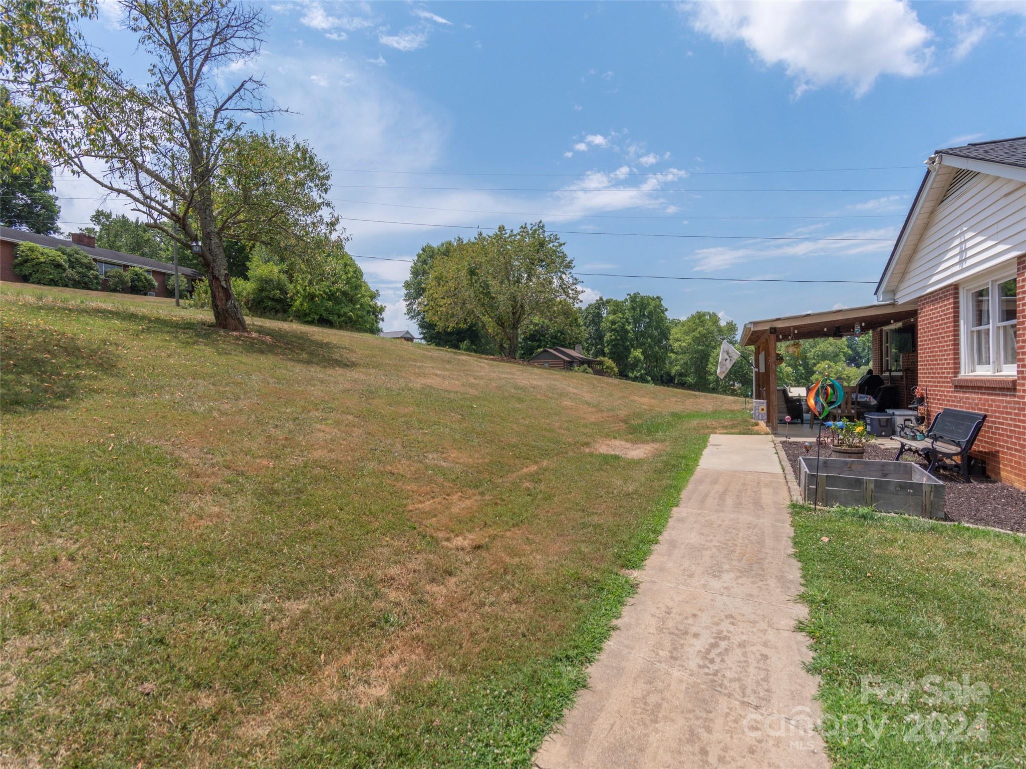 4784 Old Clyde Road Clyde, NC 28721 - Photo 22 of 23 a view of a backyard with plants and a garden
