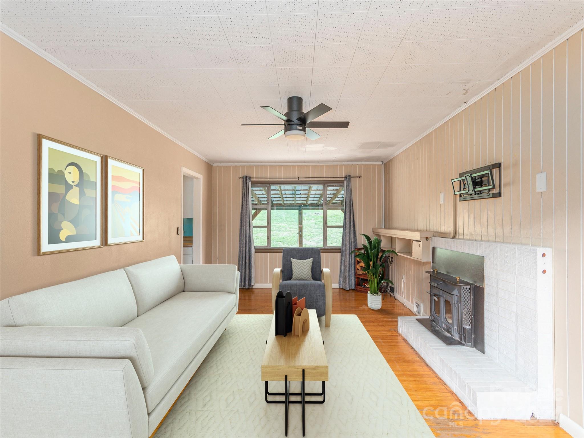 4784 Old Clyde Road Clyde, NC 28721 - Photo 6 of 23 a living room with furniture and a fireplace