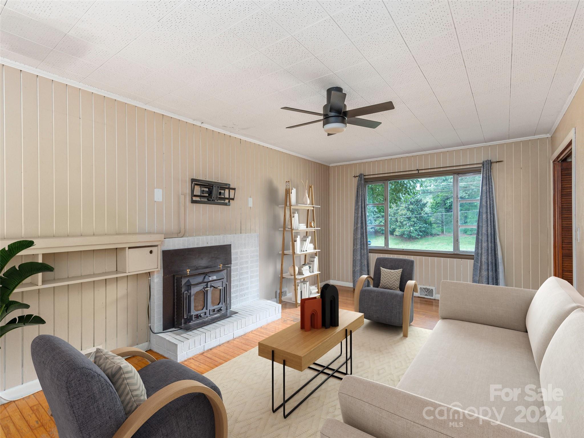 4784 Old Clyde Road Clyde, NC 28721 - Photo 7 of 23 a living room with furniture a large window and a fireplace