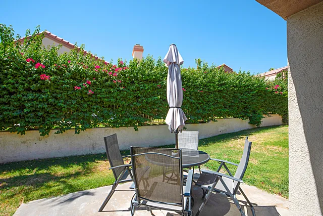 a view of a chairs and table in the patio