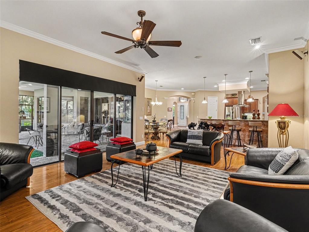 339 Corbett Road Lithia, FL 33547 - Photo 14 of 38 a living room with furniture ceiling fan and a large window
