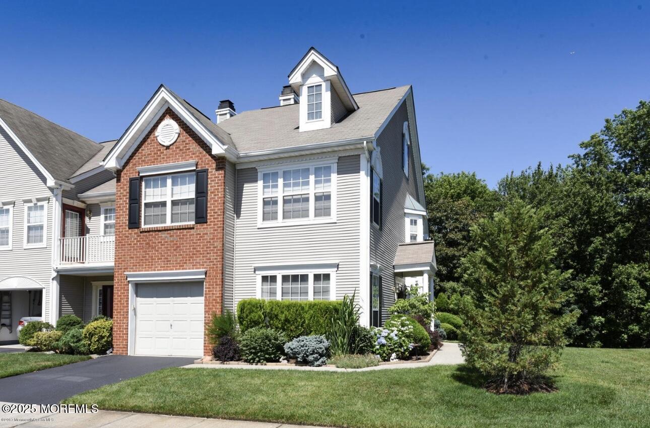 36 Alpine Road, Unit 169 Holmdel, NJ 07733 - Photo 1 of 19 a front view of a house with a yard and garage