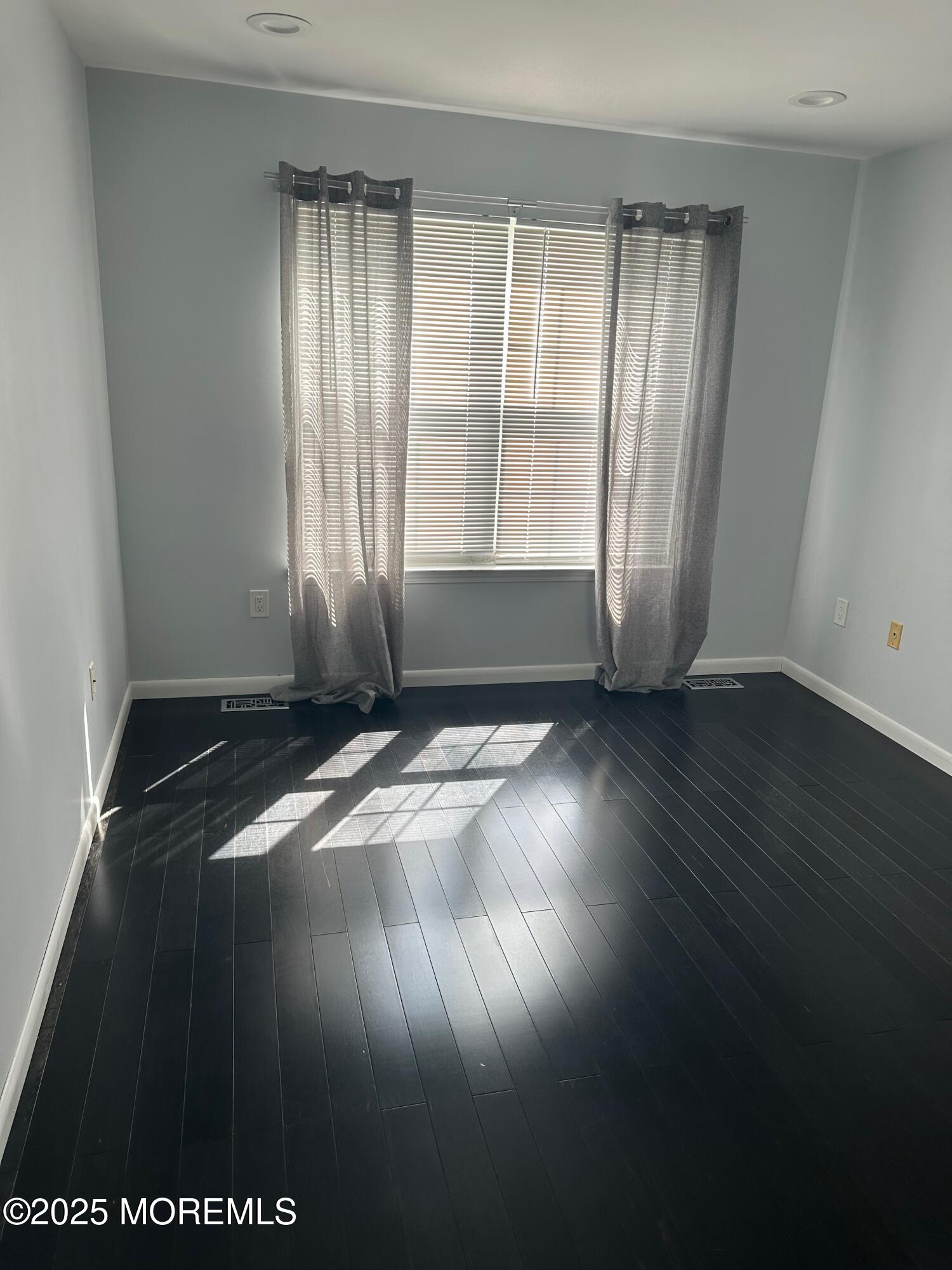 36 Alpine Road, Unit 169 Holmdel, NJ 07733 - Photo 12 of 19 an empty room with wooden floor and windows