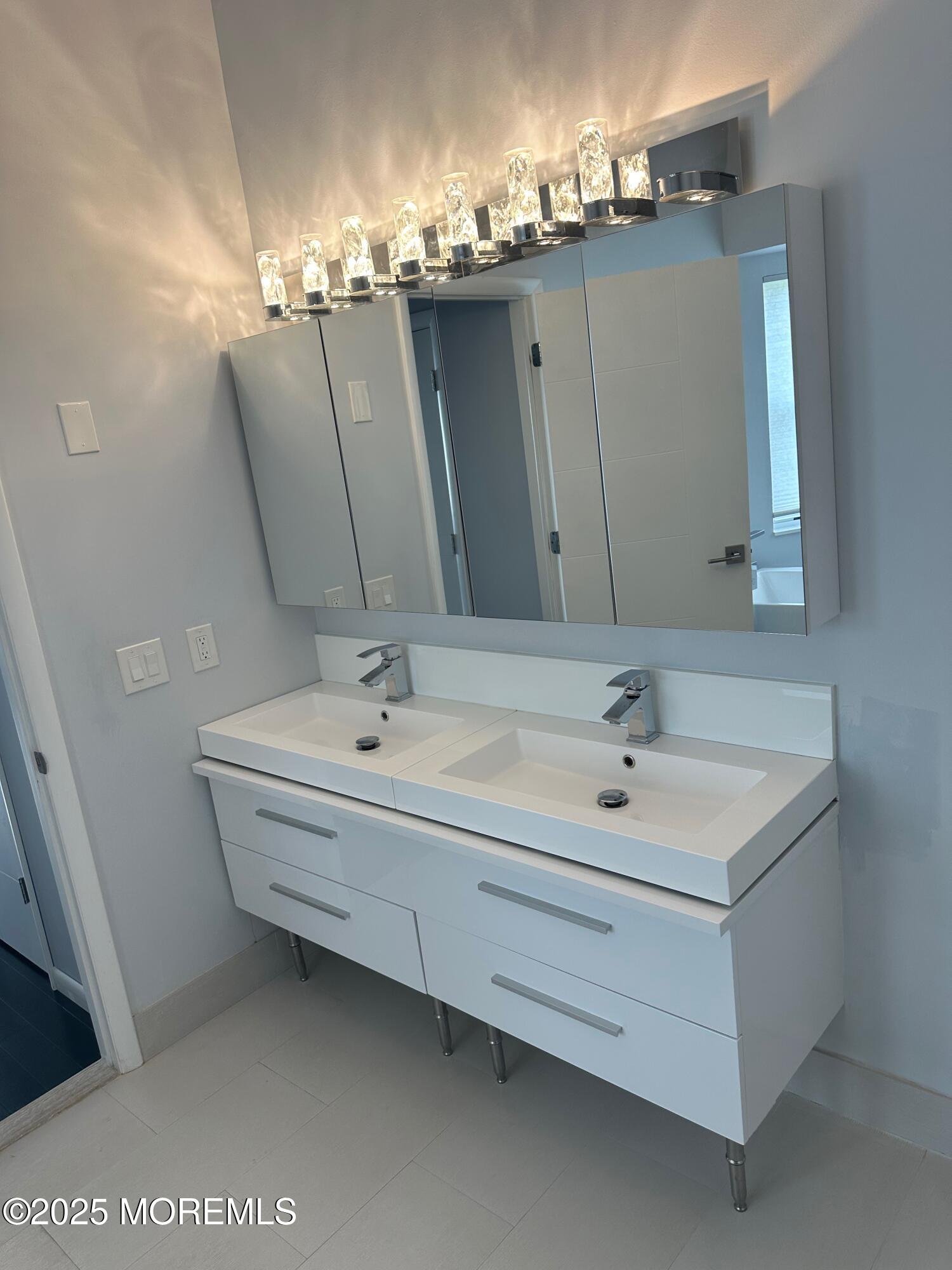 36 Alpine Road, Unit 169 Holmdel, NJ 07733 - Photo 16 of 19 a bathroom with a double vanity sink and a mirror