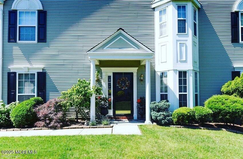 36 Alpine Road, Unit 169 Holmdel, NJ 07733 - Photo 2 of 19 a front view of a house with garden