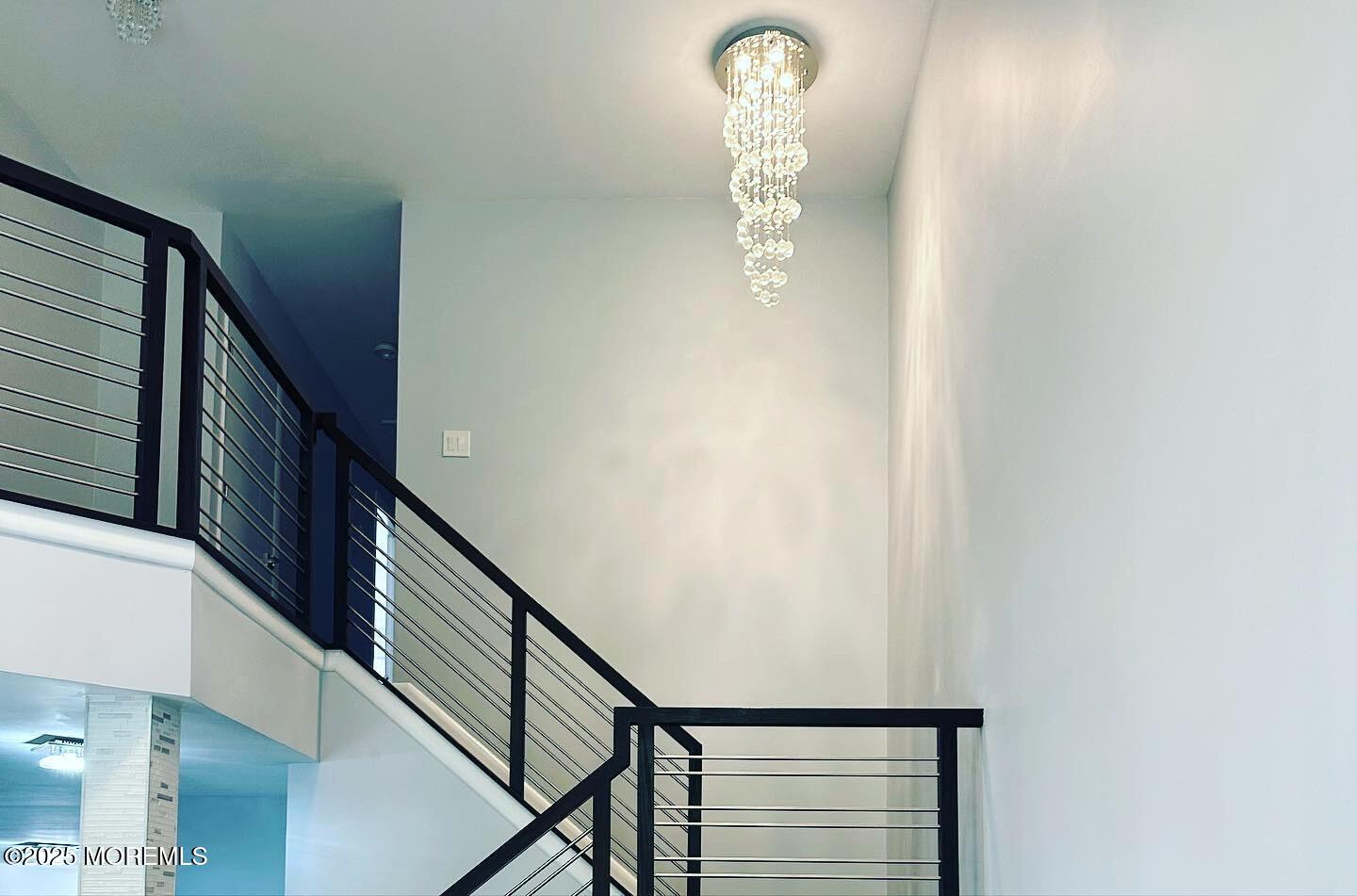 36 Alpine Road, Unit 169 Holmdel, NJ 07733 - Photo 4 of 19 a view of staircase with white walls and a window