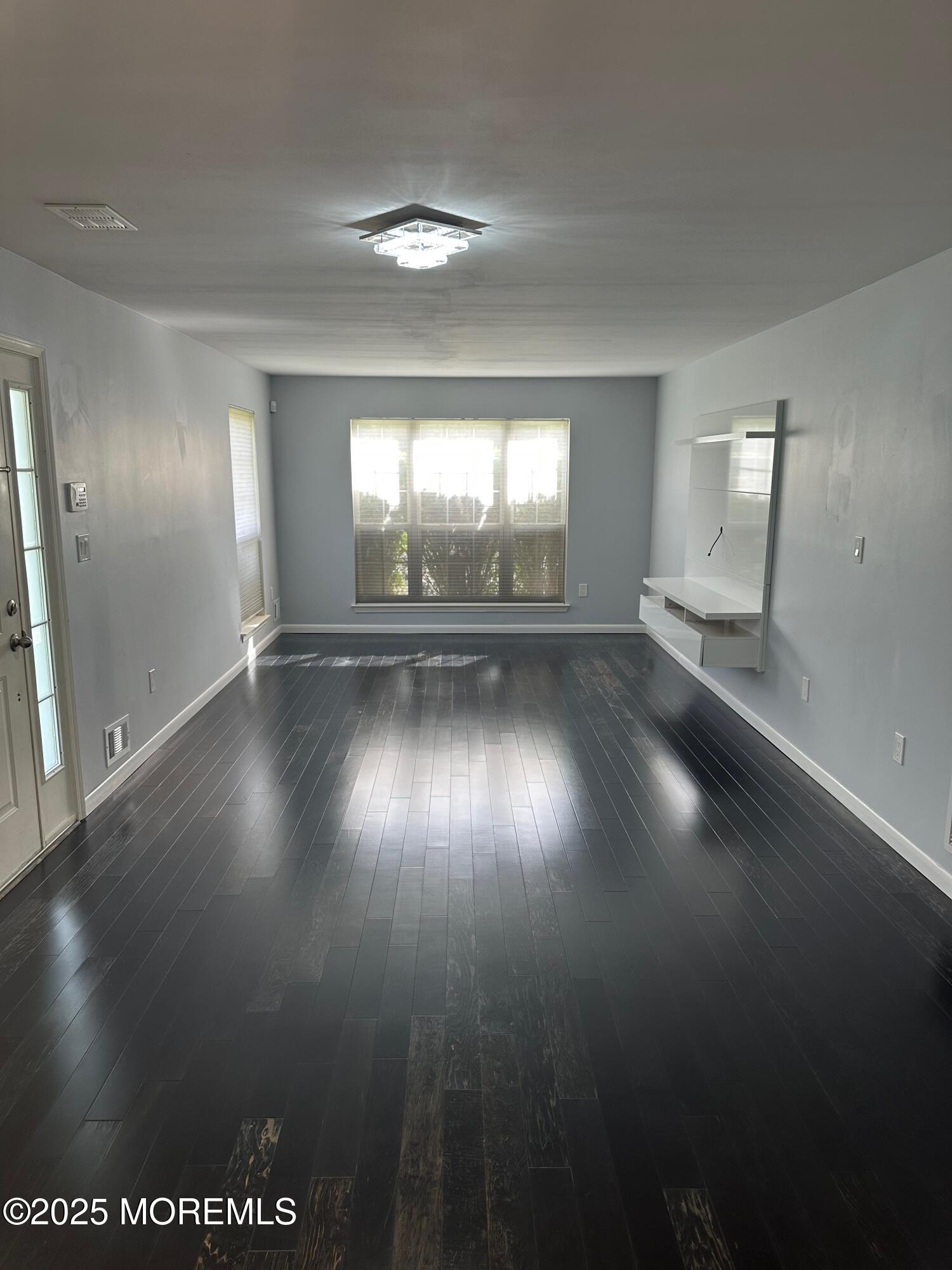 36 Alpine Road, Unit 169 Holmdel, NJ 07733 - Photo 10 of 19 an empty room with a empty space and windows
