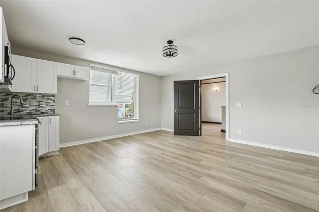 a view of kitchen with sink microwave and stove