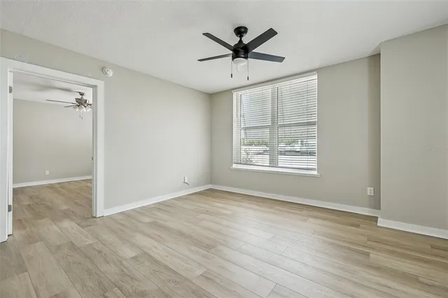 wooden floor in an empty room with a window