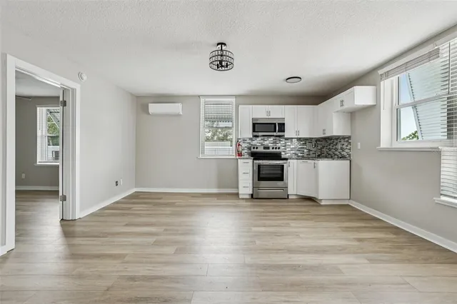 a view of kitchen with granite countertop cabinets and steel appliances
