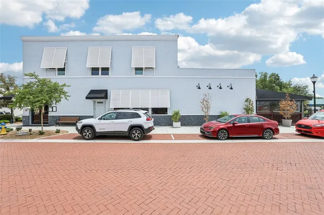 a view of cars parked in front of a house