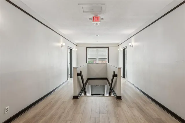 a view of a room with wooden floor and furniture
