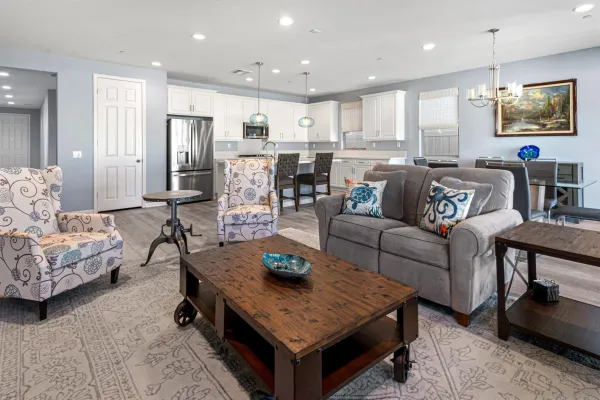 a living room with furniture kitchen view and a flat screen tv