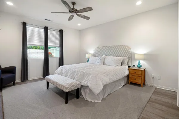 a spacious bedroom with a bed and a chandelier