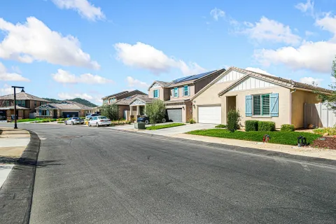 a view of a house with backyard and sitting area