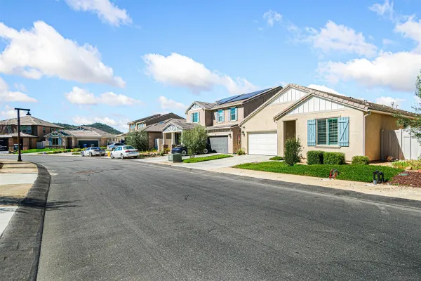a front view of multiple houses with a street