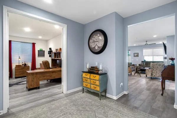 a living room with furniture and a large mirror